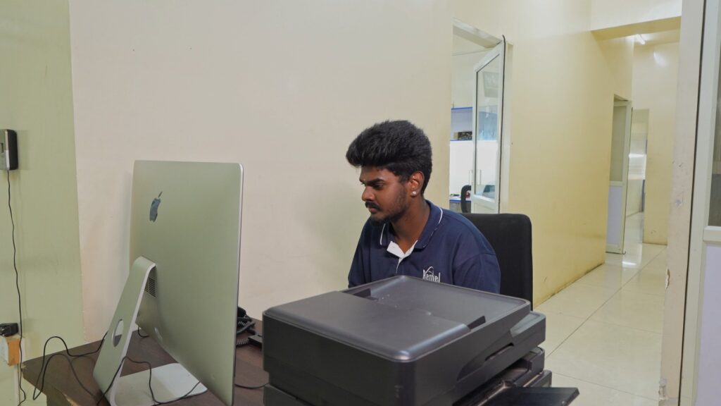 Bethel Computech team member working at a desktop workstation providing customer support and business operations.